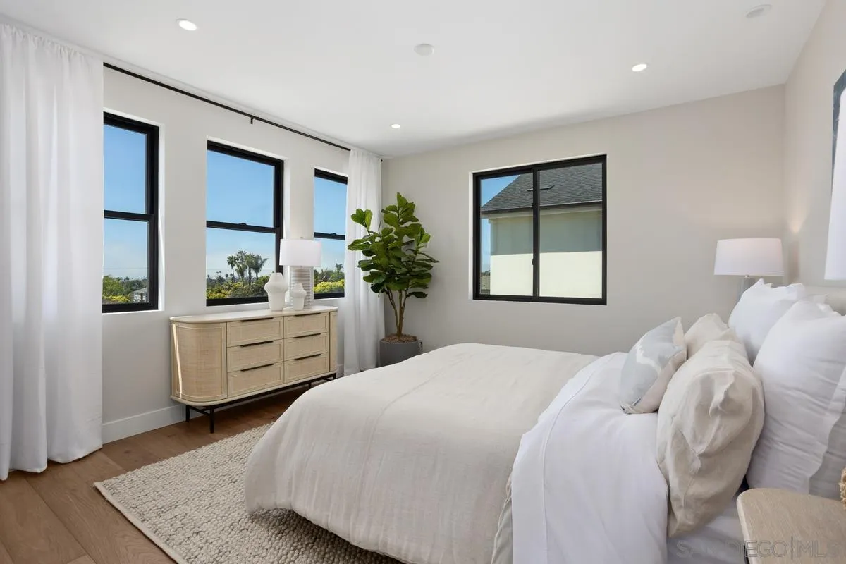 1748 Whaley Street Oceanside, CA 92054 - Photo 21 of 38 a bedroom with a large bed and windows