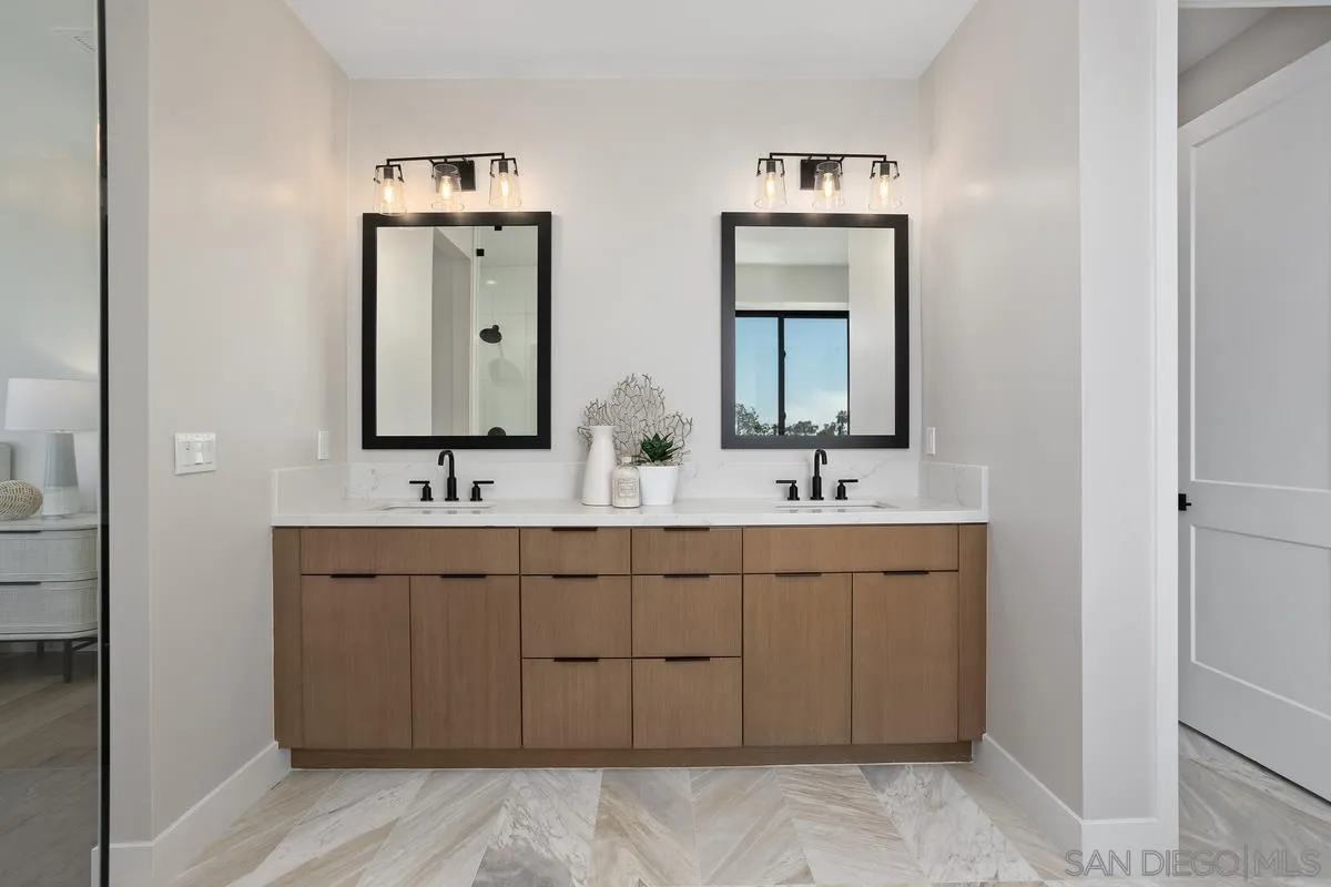 1748 Whaley Street Oceanside, CA 92054 - Photo 23 of 38 a bathroom with double vanity sinks and a mirror