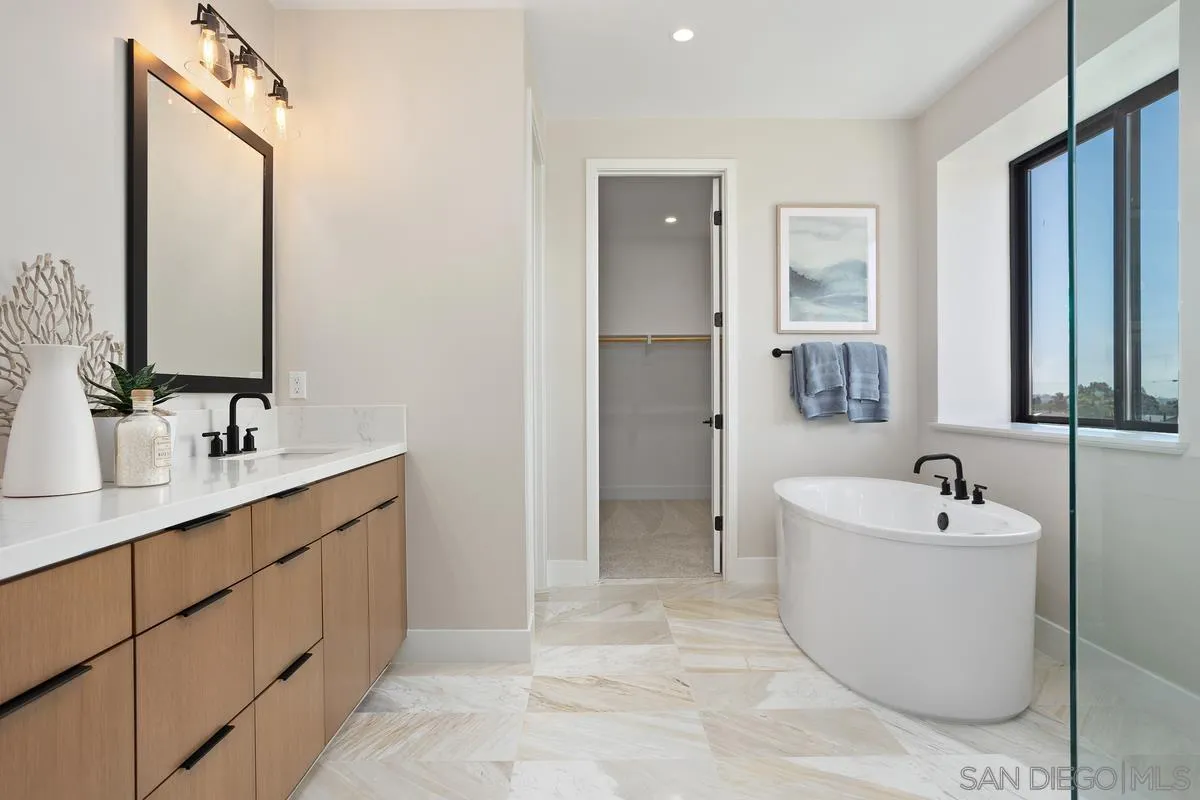 1748 Whaley Street Oceanside, CA 92054 - Photo 25 of 38 a spacious bathroom with a bathtub sink and mirror