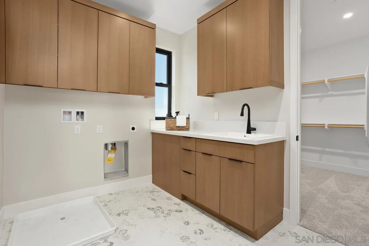 1748 Whaley Street Oceanside, CA 92054 - Photo 27 of 38 a bathroom with a sink and a mirror