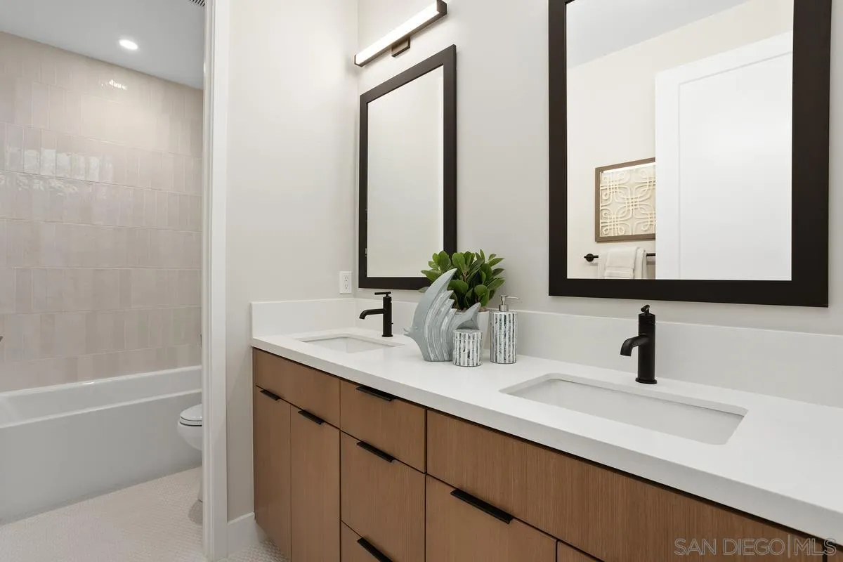 1748 Whaley Street Oceanside, CA 92054 - Photo 29 of 38 a bathroom with a sink and a mirror