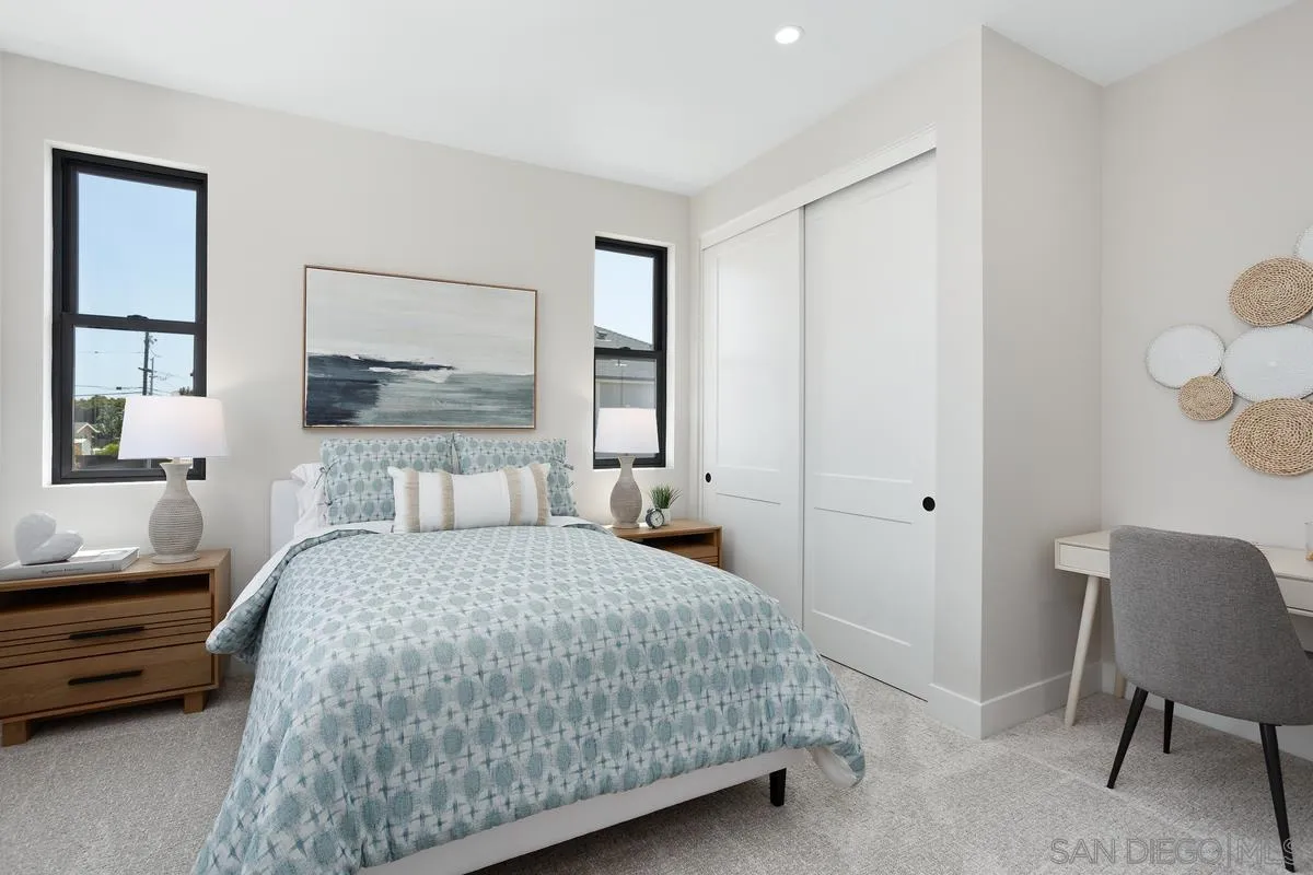 1748 Whaley Street Oceanside, CA 92054 - Photo 30 of 38 a bedroom with a bed a mirror and furniture
