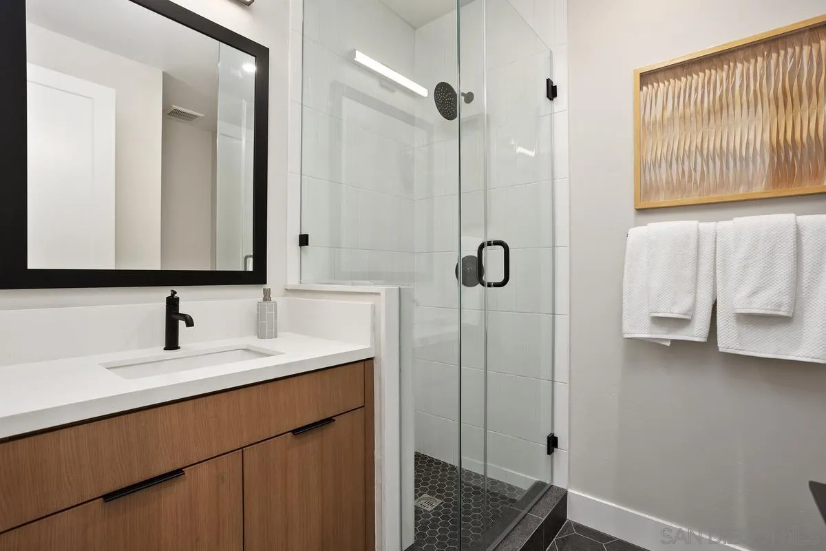 1748 Whaley Street Oceanside, CA 92054 - Photo 33 of 38 a bathroom with a sink and a mirror