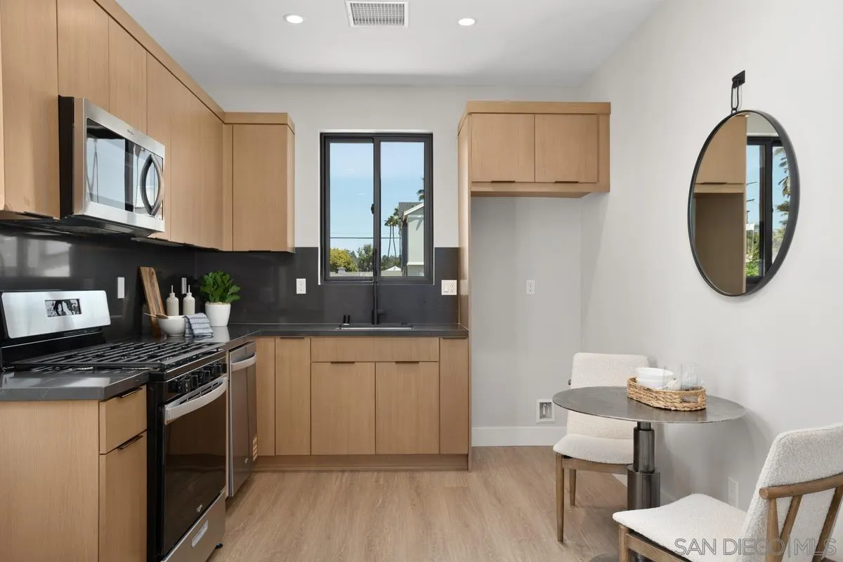 1748 Whaley Street Oceanside, CA 92054 - Photo 37 of 38 a kitchen with stainless steel appliances granite countertop a stove a sink and a microwave