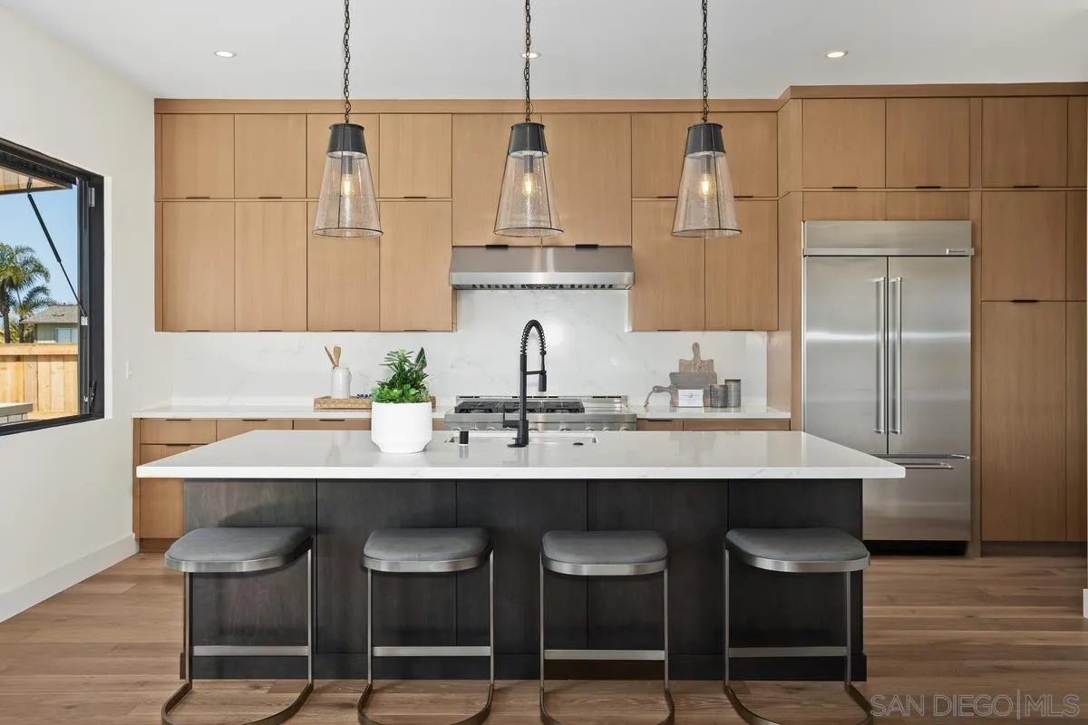 1748 Whaley Street Oceanside, CA 92054 - Photo 7 of 38 a kitchen with stainless steel appliances granite countertop a sink a stove a refrigerator and island with wooden floor