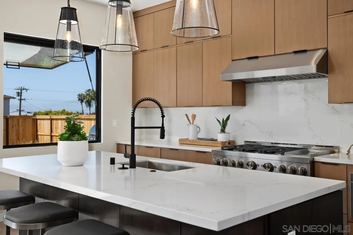 1748 Whaley Street Oceanside, CA 92054 - Photo 8 of 38 a kitchen with a sink a stove and chairs