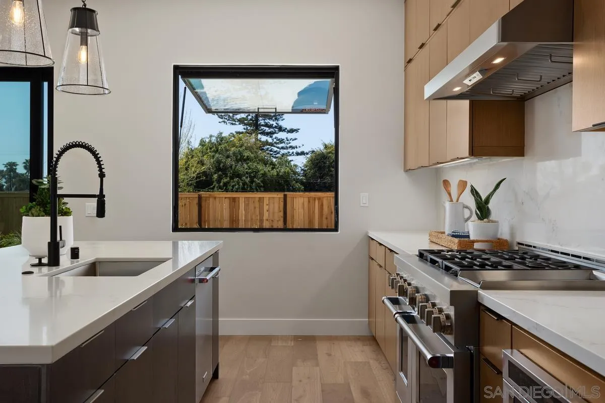 1748 Whaley Street Oceanside, CA 92054 - Photo 10 of 38 a kitchen with sink a microwave and stove