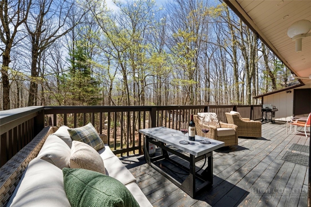 811 Pine Ridge Road Beech Mountain, NC 28604 - Photo 20 of 26 a roof deck with couches and wooden floor