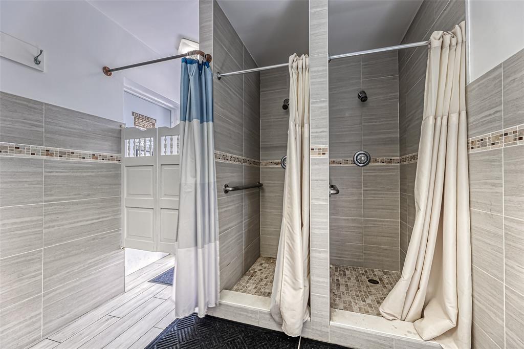 2220 Northeast 68th Street, Unit 1005 Fort Lauderdale, FL 33308 - Photo 16 of 25 a bathroom with a glass shower door