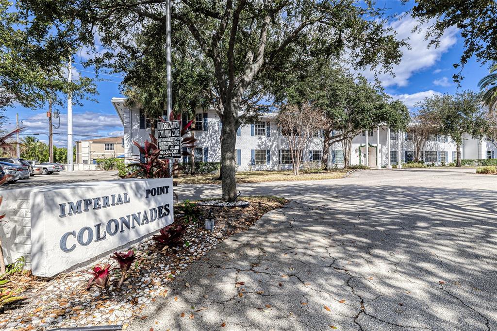 2220 Northeast 68th Street, Unit 1005 Fort Lauderdale, FL 33308 - Photo 2 of 25 a street sign on a sidewalk next to a road