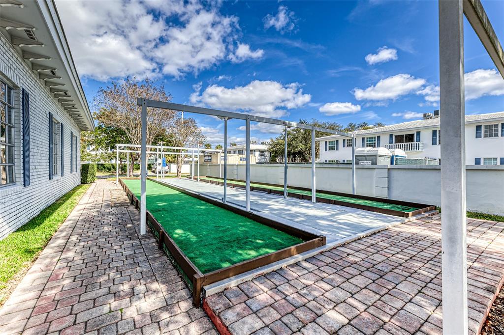 2220 Northeast 68th Street, Unit 1005 Fort Lauderdale, FL 33308 - Photo 21 of 25 a view of a backyard with wooden fence