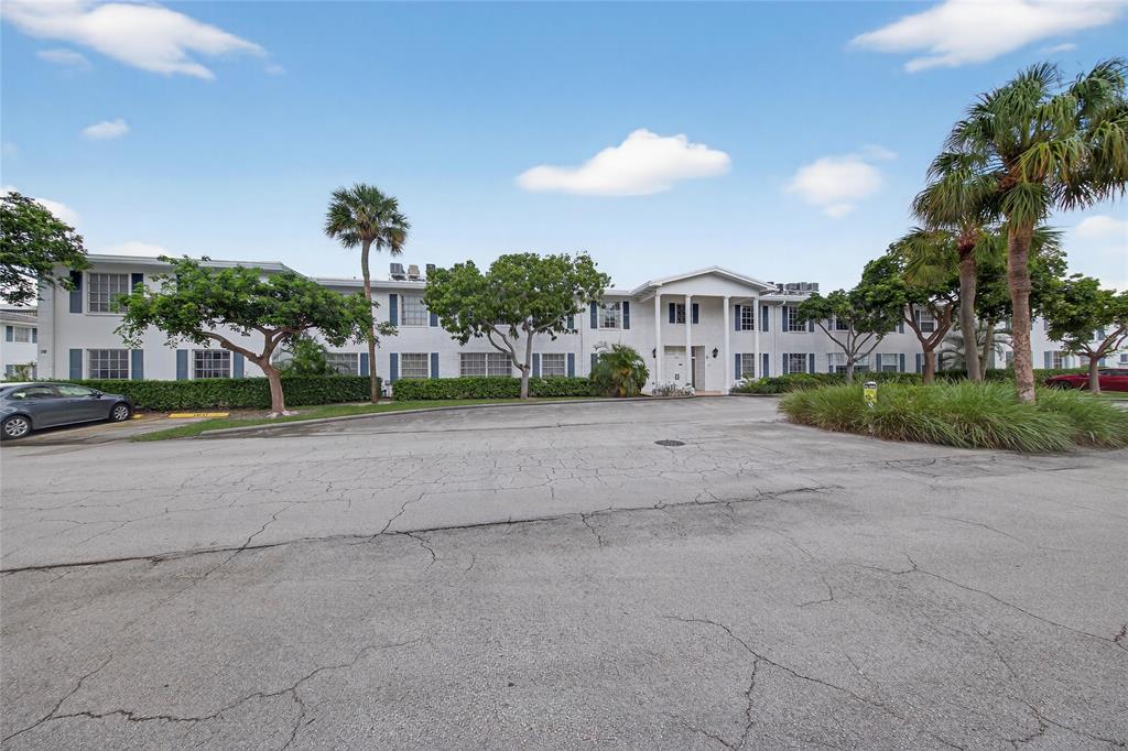 2220 Northeast 68th Street, Unit 1005 Fort Lauderdale, FL 33308 - Photo 3 of 25 a view of a house with a yard and large trees
