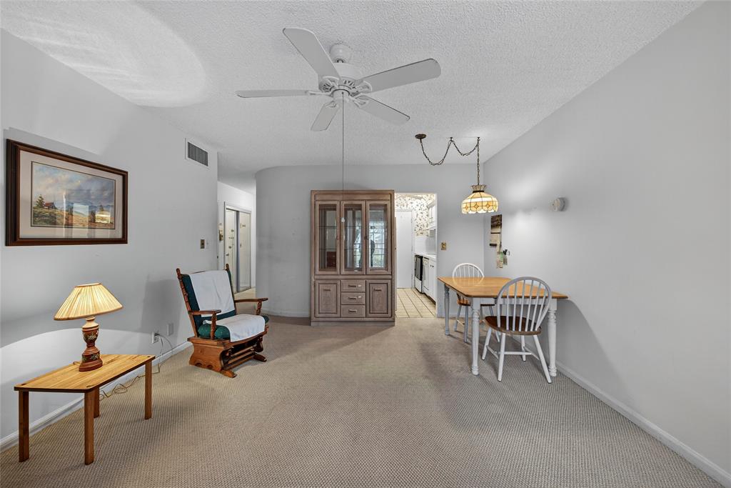 2220 Northeast 68th Street, Unit 1005 Fort Lauderdale, FL 33308 - Photo 6 of 25 a dining room with furniture and window