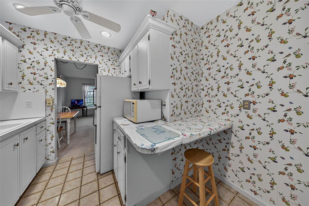 2220 Northeast 68th Street, Unit 1005 Fort Lauderdale, FL 33308 - Photo 8 of 25 a kitchen with stainless steel appliances a stove a sink and a refrigerator