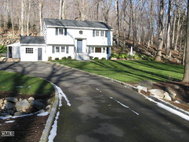 79 Cooper Road Ridgefield, CT 06877 - Photo 1 of 1 a front view of a house with a yard