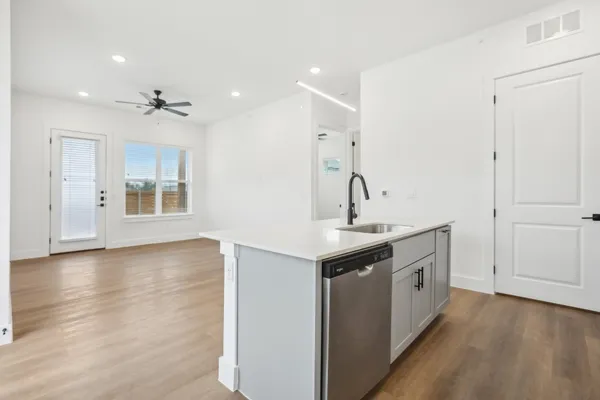 a view of a kitchen with sink and dishwasher