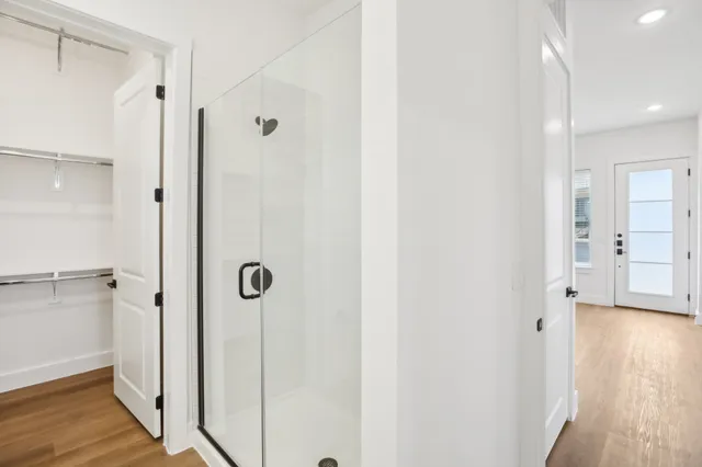 a bathroom with a shower and a glass door