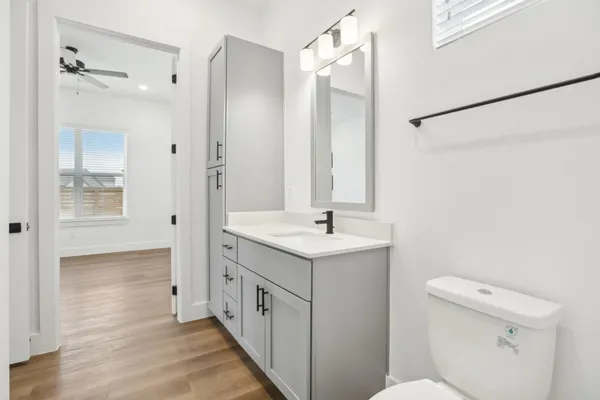 a bathroom with a sink a toilet and shower