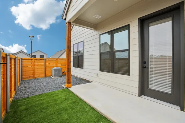a view of a house with backyard and porch