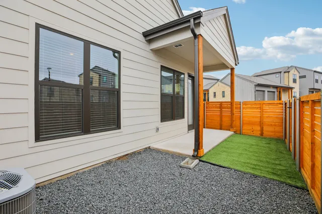 a view of a house with backyard and porch