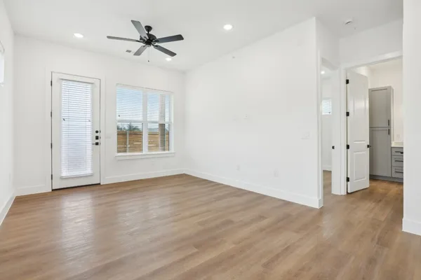 wooden floor in an empty room with a window