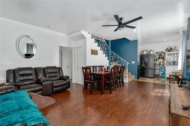 a dining room with furniture and wooden floor
