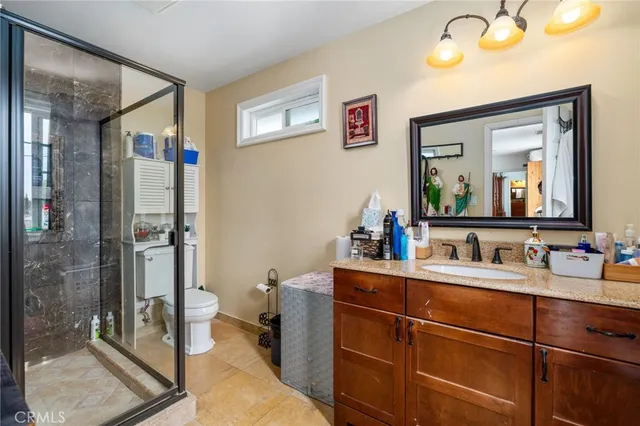 a bedroom with a bed couch and a flat screen tv