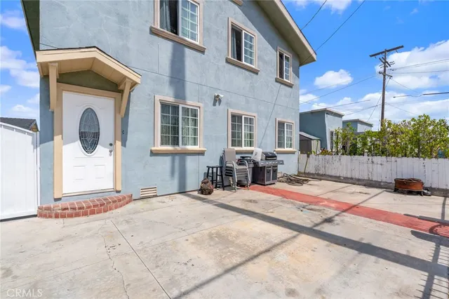 a building outdoor space with patio furniture and potted plants