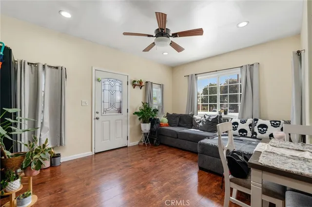 a view of a dining room with furniture and wooden floor
