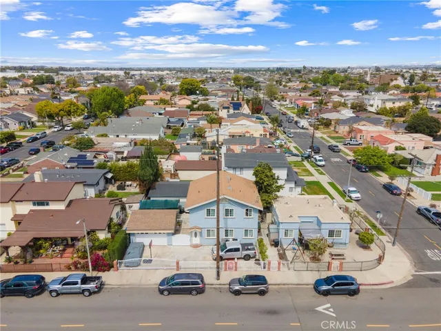 an aerial view of a residential houses with yard