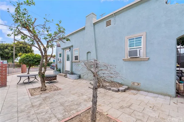 a row of furniture and a potted plants in front of a house