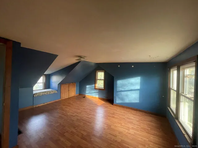 a view of empty room with a kitchen and window