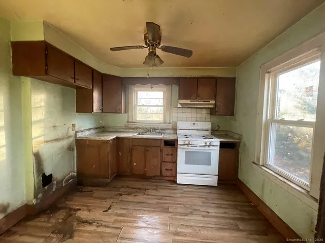 a kitchen with a stove a sink and a refrigerator