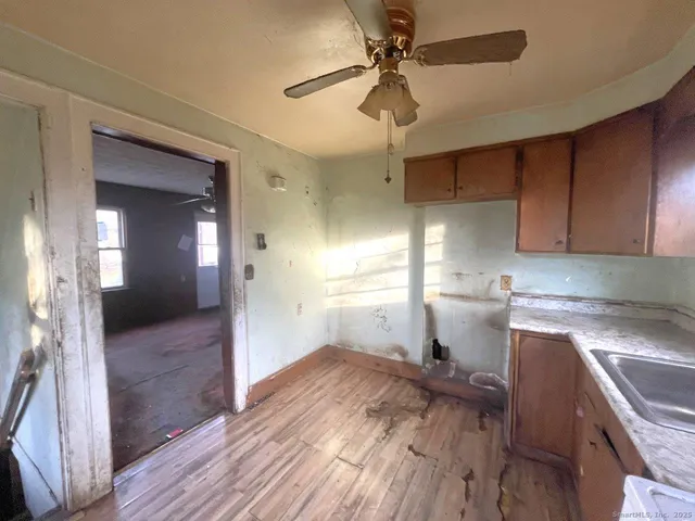a very nice looking room with wooden floor and cabinets