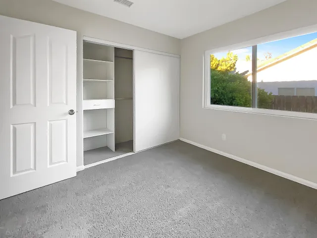 an empty room with windows and mountain view