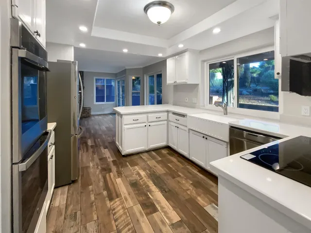 a kitchen that has a sink and a stove in it