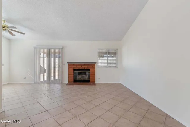 a view of an empty room with a fireplace