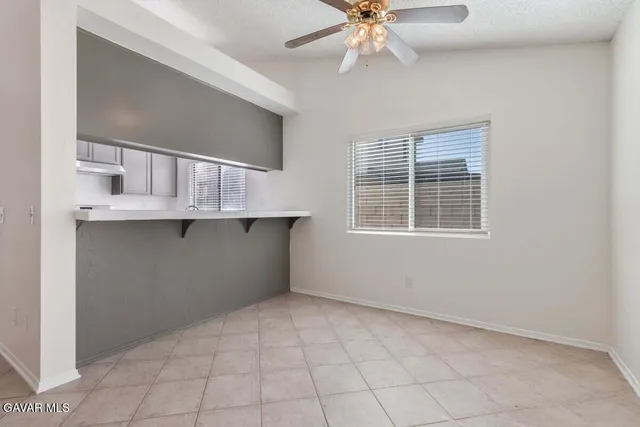 a kitchen with stainless steel appliances granite countertop a sink stove cabinets and a window