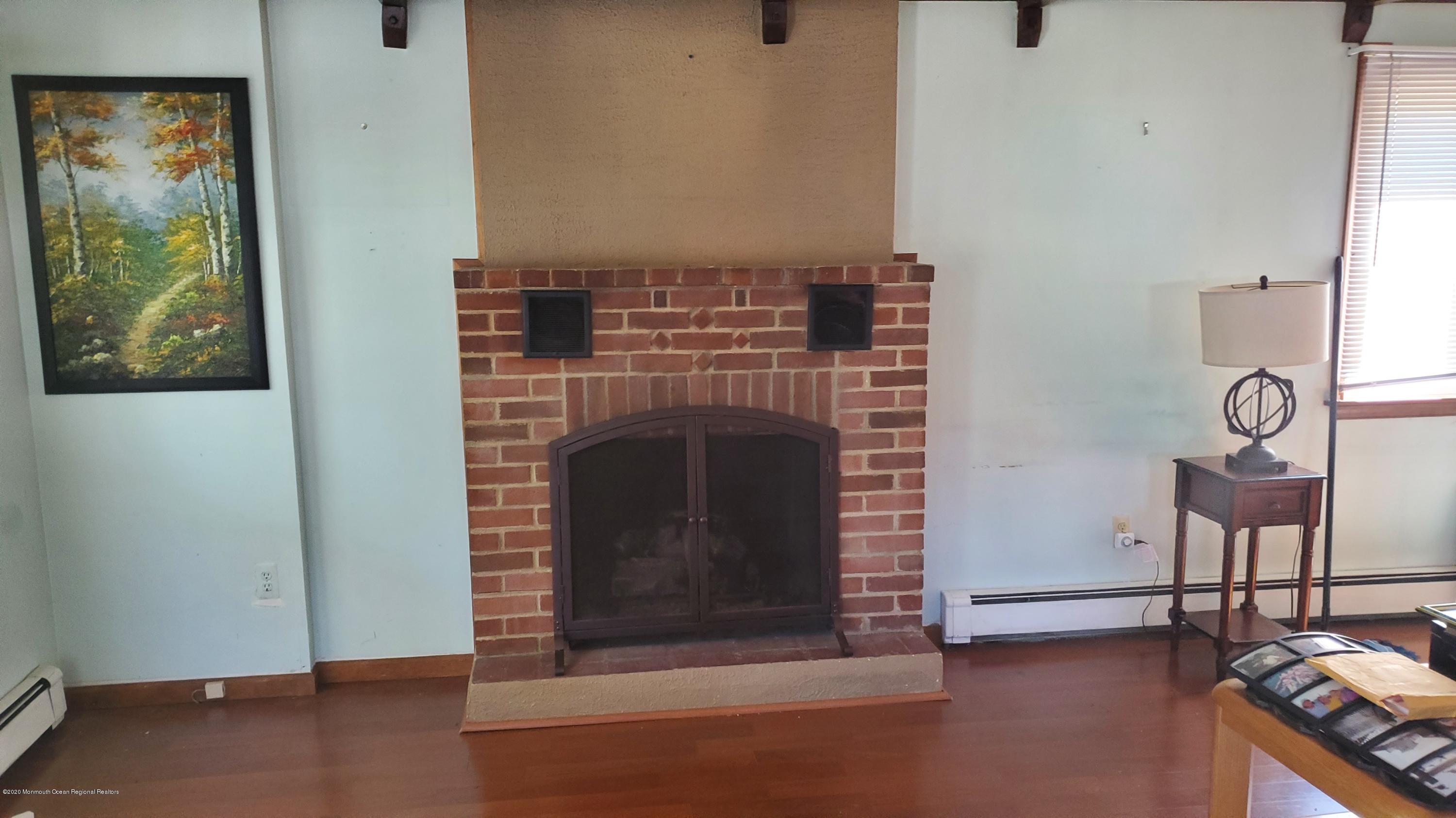 2226 Kenneth Road Point Pleasant, NJ 08742 - Photo 4 of 5 a living room with furniture and a fireplace