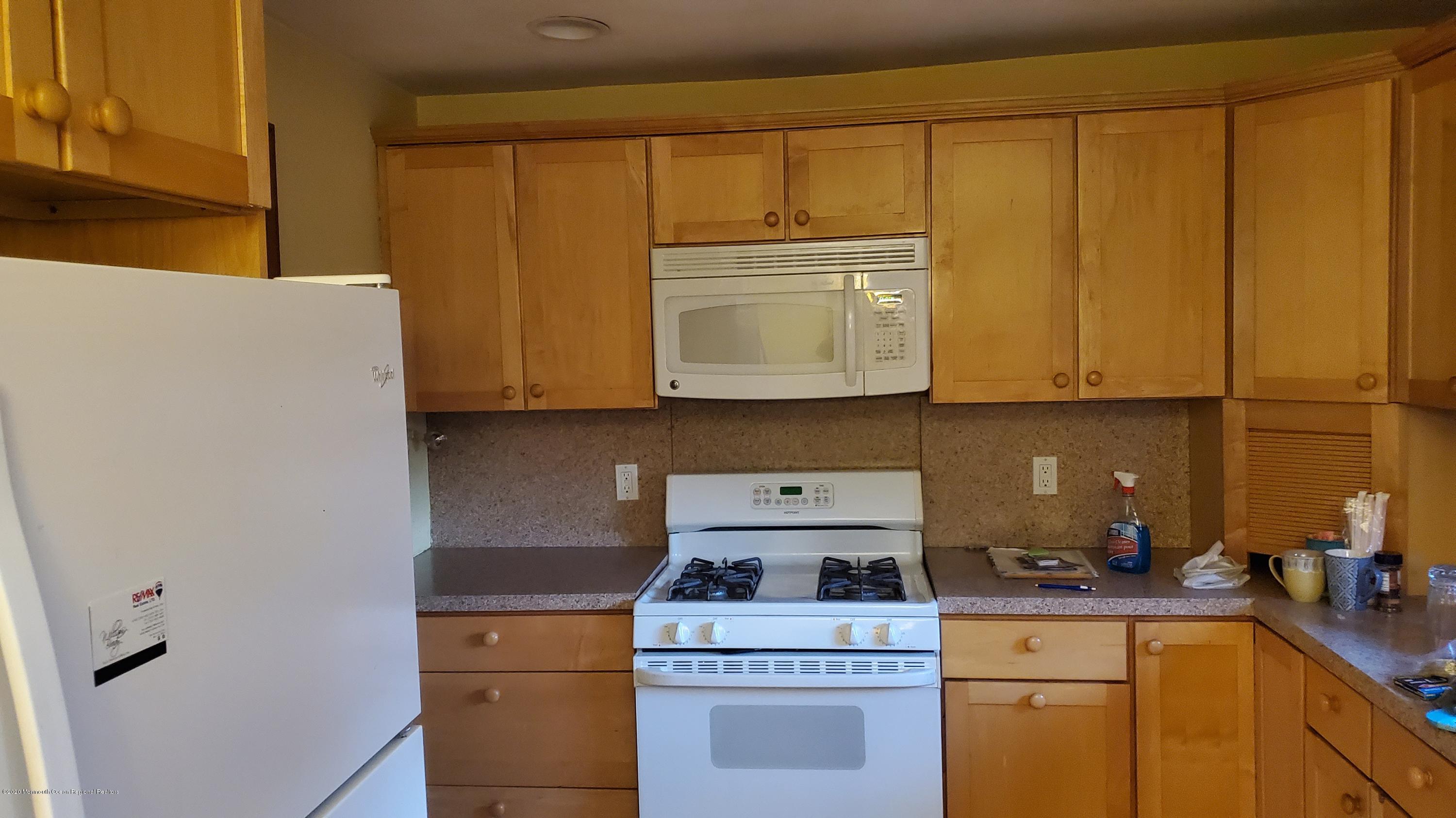 2226 Kenneth Road Point Pleasant, NJ 08742 - Photo 5 of 5 a kitchen with a stove and a microwave