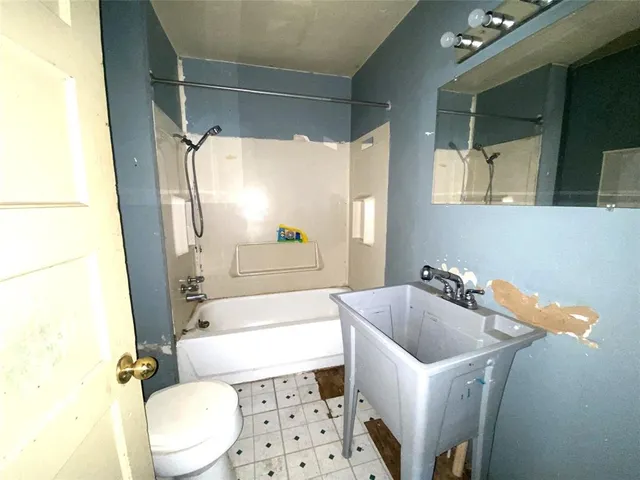 a bathroom with a sink a bathtub and toilet