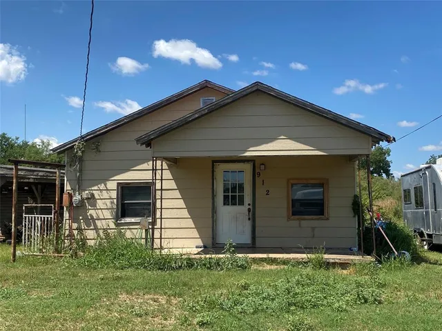 a front view of a house with yard