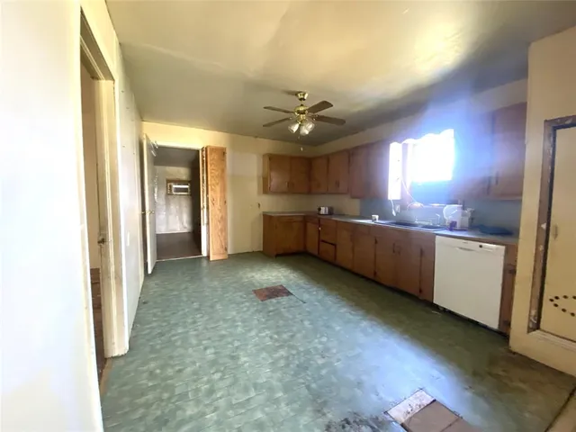 a kitchen with lot of cabinets and window