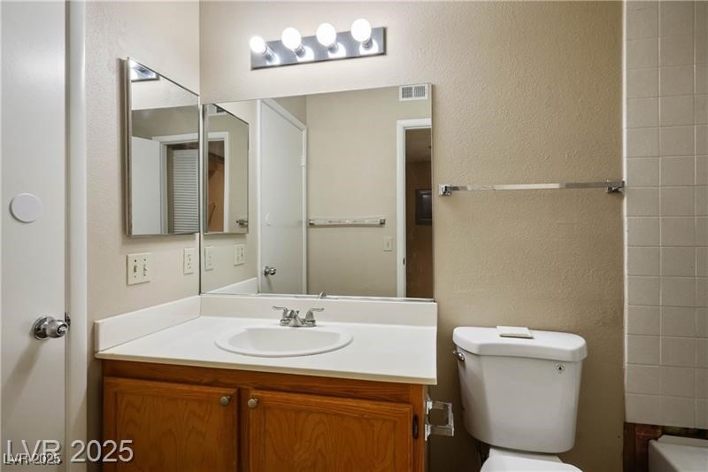 1575 West Warm Springs Road, Unit 2122 Henderson, NV 89014 - Photo 21 of 24 Bathroom featuring vanity, a textured wall, and bathtub / shower combination