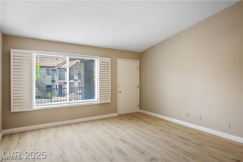 1575 West Warm Springs Road, Unit 2122 Henderson, NV 89014 - Photo 7 of 24 Empty room with light wood-style flooring and baseboards
