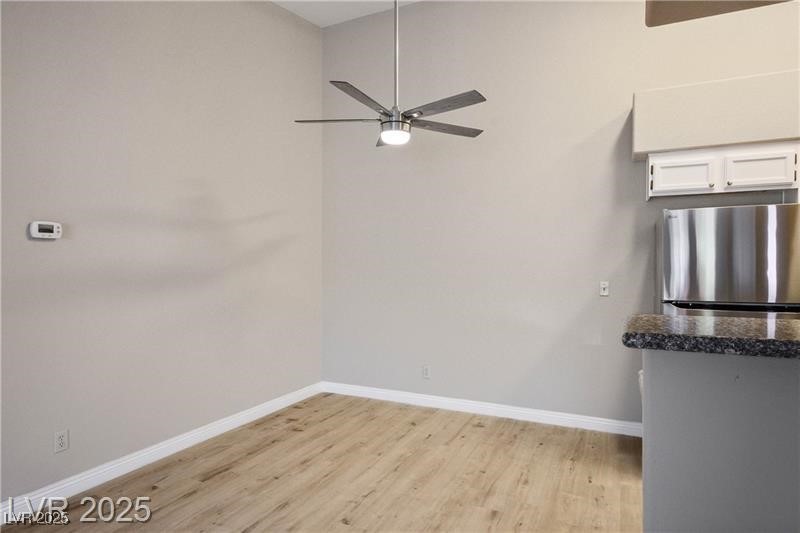 1575 West Warm Springs Road, Unit 2122 Henderson, NV 89014 - Photo 8 of 24 Unfurnished dining area featuring light wood-type flooring and ceiling fan
