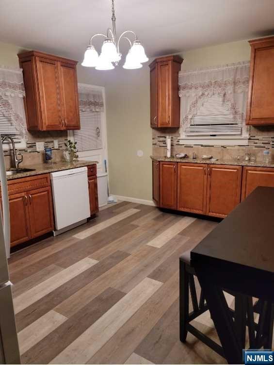 110 Church Street, Unit 1 Lodi, NJ 07644 - Photo 2 of 7 a kitchen with stainless steel appliances granite countertop a sink and a stove with wooden floor