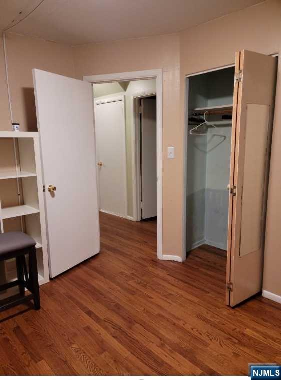 110 Church Street, Unit 1 Lodi, NJ 07644 - Photo 3 of 7 an empty room with wooden floor and closet