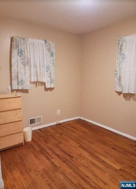 110 Church Street, Unit 1 Lodi, NJ 07644 - Photo 4 of 7 a view of a kitchen with wooden floor and cabinets