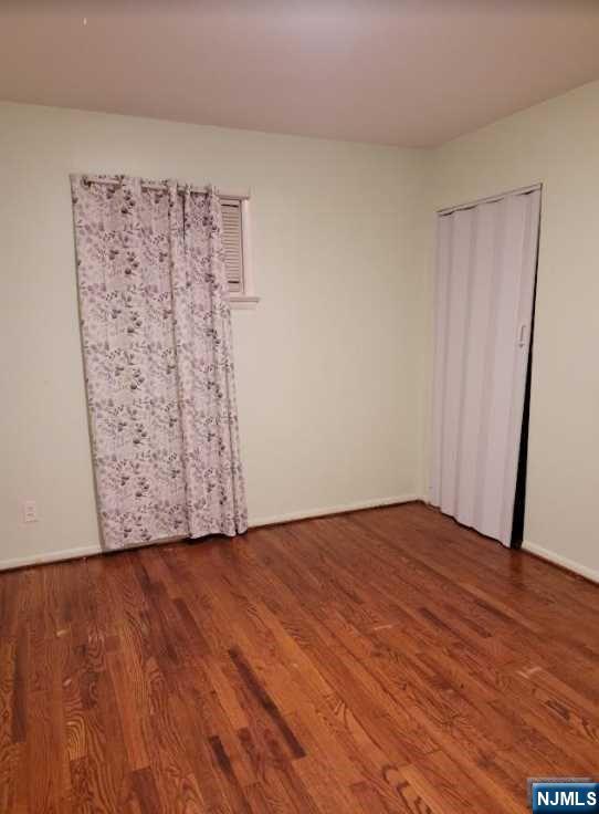 110 Church Street, Unit 1 Lodi, NJ 07644 - Photo 5 of 7 a view of a room with wooden floor and a wall painting